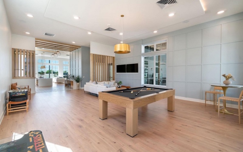lounge room with a pool table and on wooden flooring