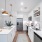 long kitchen with stainless steel appliances and kitchen island in Austin apartment