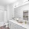 all white bathroom with large mirror in Austin apartment