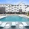 Resort-style pool with lounge chairs at Citizen House Blue Bluff apartments in East Austin, TX.