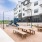 Outdoor playground with slide and picnic tables at Citizen House Blue Bluff apartments in East Austin, TX.