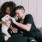 Lifestyle image of a couple playing with their dog on their bed