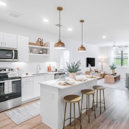 kitchen with ample counter-space, modern appliances and bright lighting