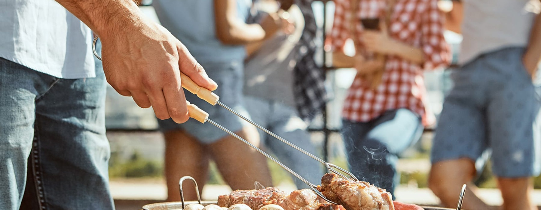 lifestyle image of a person grilling outdoors